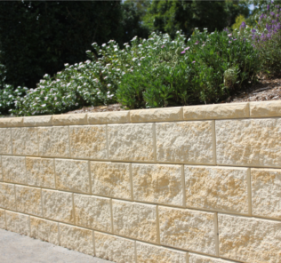 Vertical_faced_retaining_wall_Fraser_Sand_with_raised_garden_including_hedges_and_flowers
