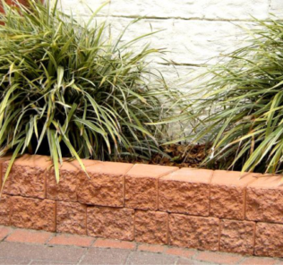Terracotta_weed_free_garden_edging_blocks_with_grass_plant