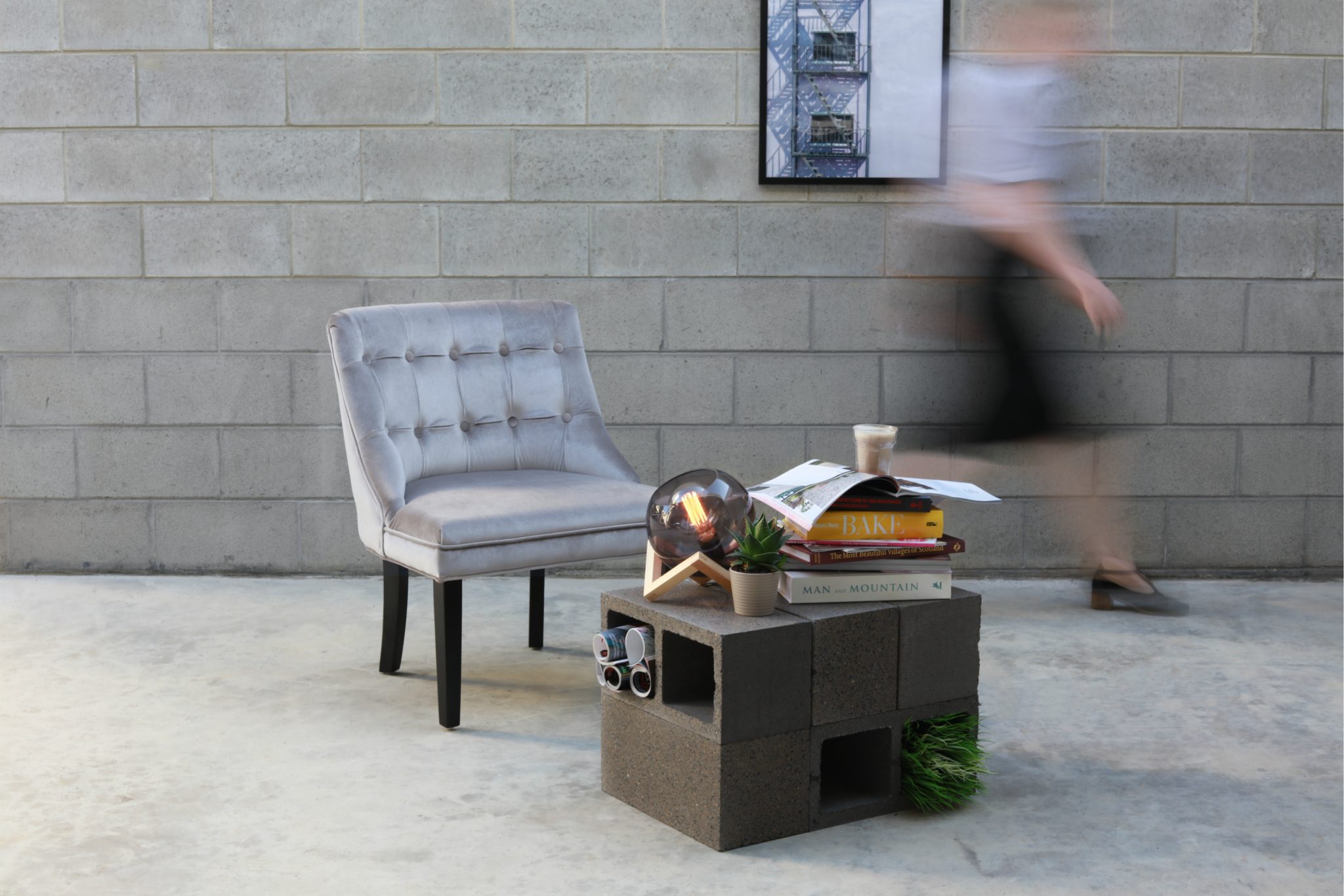Modern_industrial_living_room_setting_with_a_person_walking_past_a_Polished_Charcoal_coloured_block_coffee_table