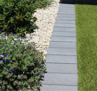 A_garden_border_and_mowing_strip_using_200x100x40mm_pavers_charcoal