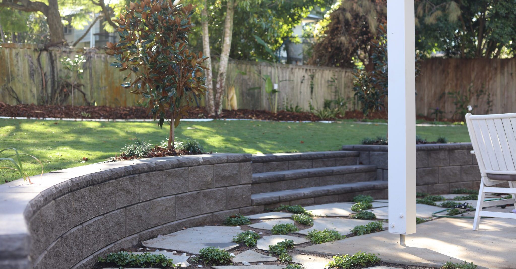 TrendStone_Retaining_Wall_Charcoal_with_stairs_beside_a_outdoor_living_area